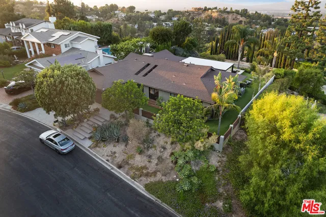 an aerial view of multiple houses with yard
