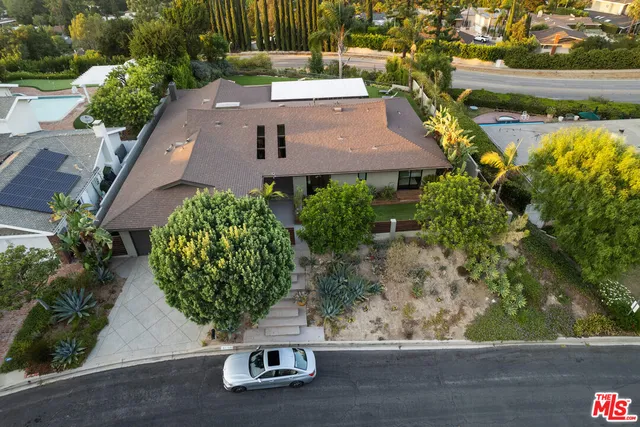 an aerial view of a house with a yard and lake view