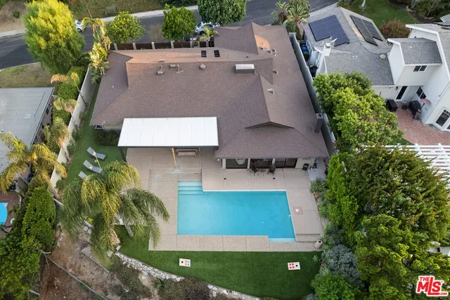 an aerial view of a house with a yard