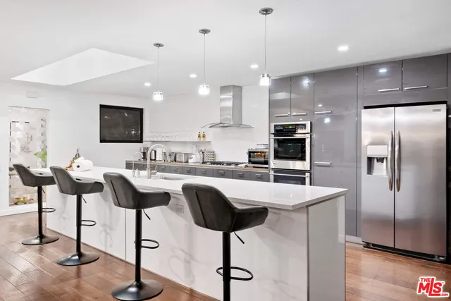a kitchen with cabinets and stainless steel appliances