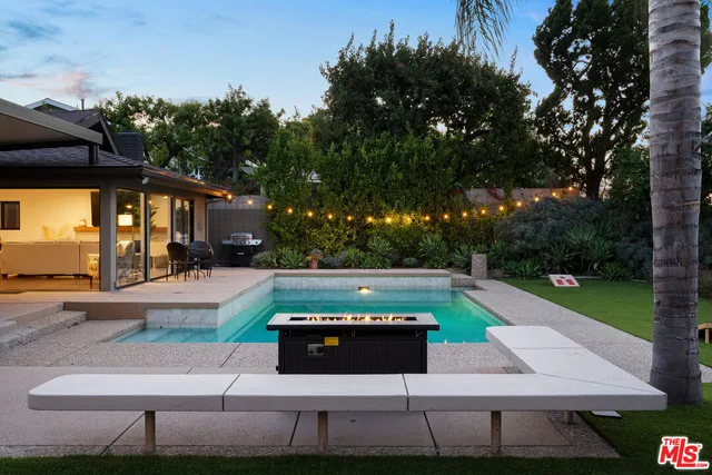 a view of a patio with chairs and a yard