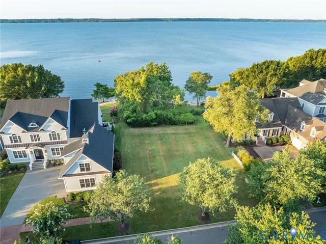 an aerial view of a house with a lake view
