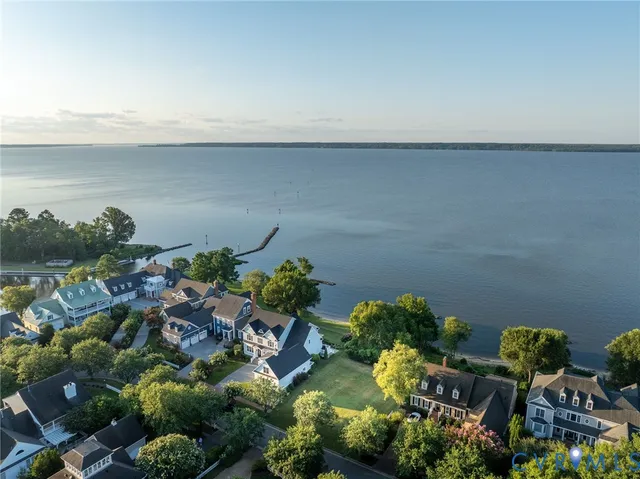 a view of a house with wooden deck and furniture