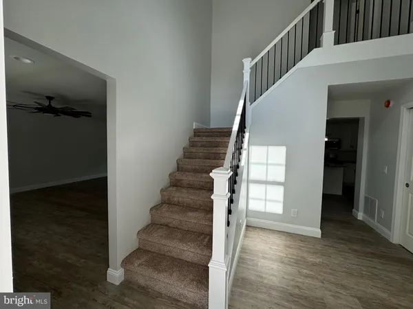 a view of entryway and hall with wooden floor