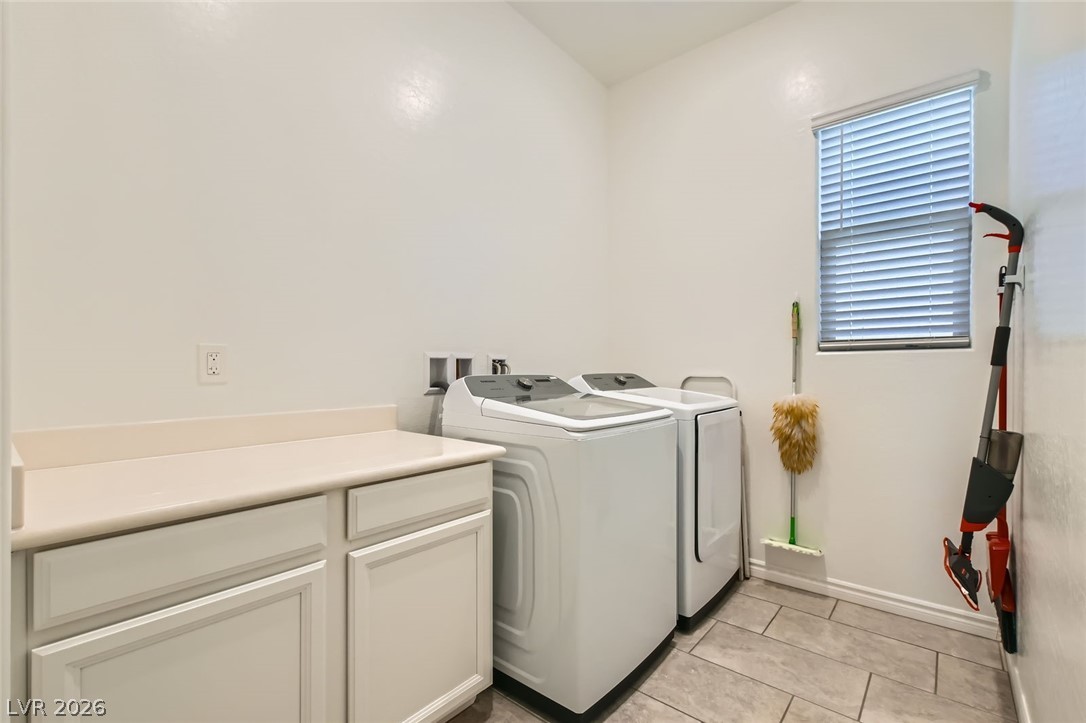 498 Pebble Run Avenue Henderson, NV 89011 - Photo 19 of 47 Functional laundry space featuring modern appliances and a convenient counter for folding.
