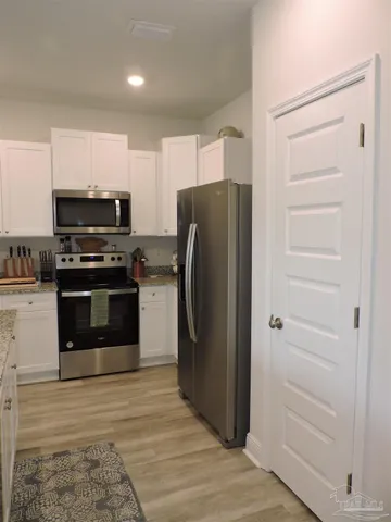 a kitchen with a sink appliances and cabinets