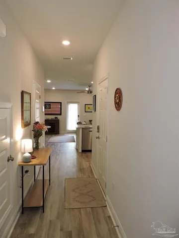 a living room with furniture and a table with wooden floor