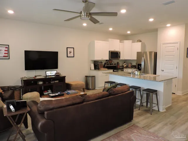 a kitchen with refrigerator and chairs