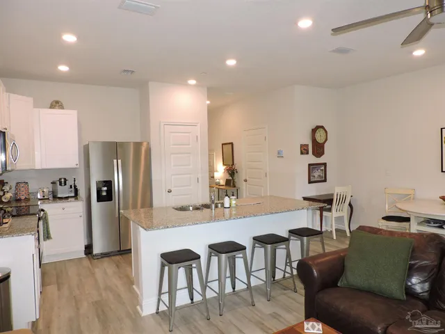a kitchen with stainless steel appliances granite countertop a refrigerator and a stove