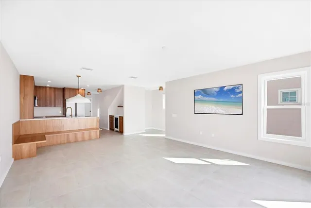 a spacious bedroom with a bed and a window