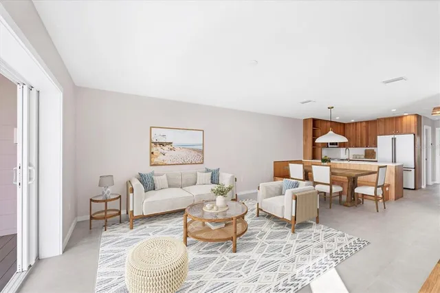 a living room with furniture and a dining table