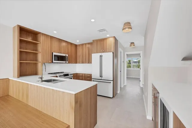 a kitchen with stainless steel appliances a refrigerator stove and microwave