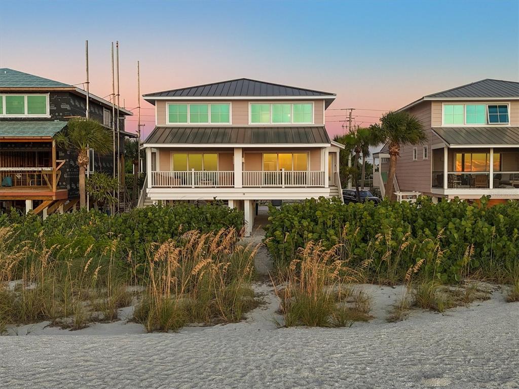 290 Gulf Boulevard, Unit 18 Boca Grande, FL 33921 - Photo 2 of 49 a front view of a house with a yard