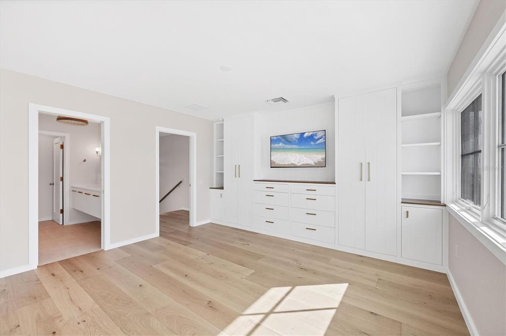 290 Gulf Boulevard, Unit 18 Boca Grande, FL 33921 - Photo 25 of 49 a view of a bedroom with wooden floor and cabinet