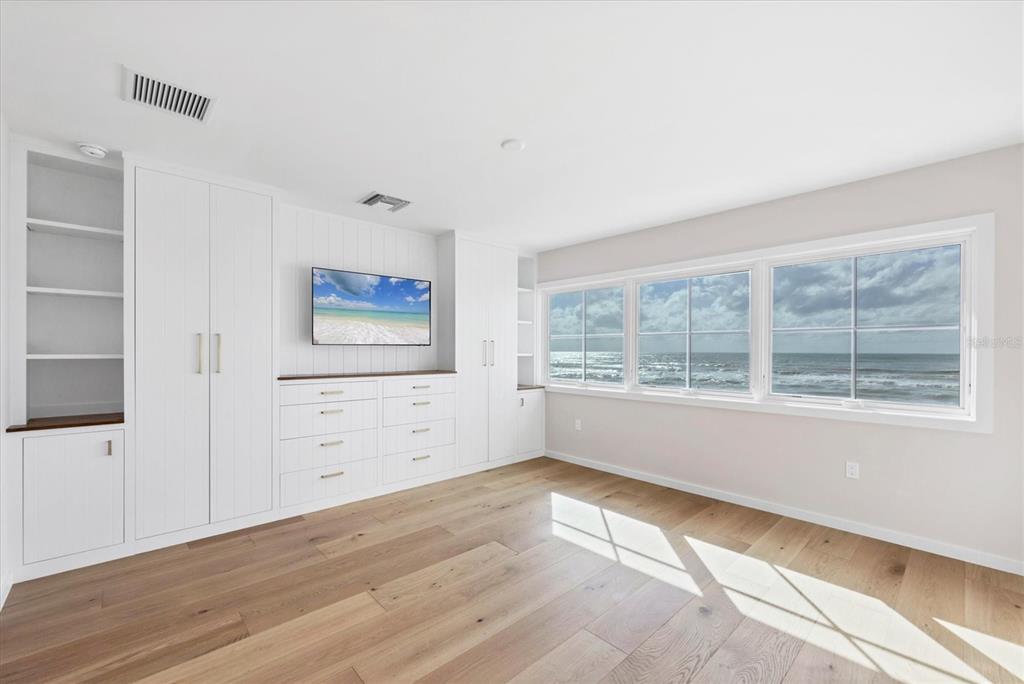 290 Gulf Boulevard, Unit 18 Boca Grande, FL 33921 - Photo 28 of 49 an empty room with wooden floor and windows