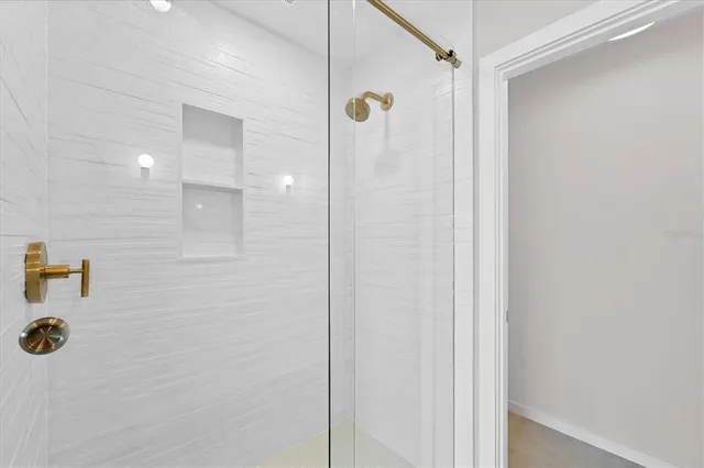 a bathroom with a shower and a sink