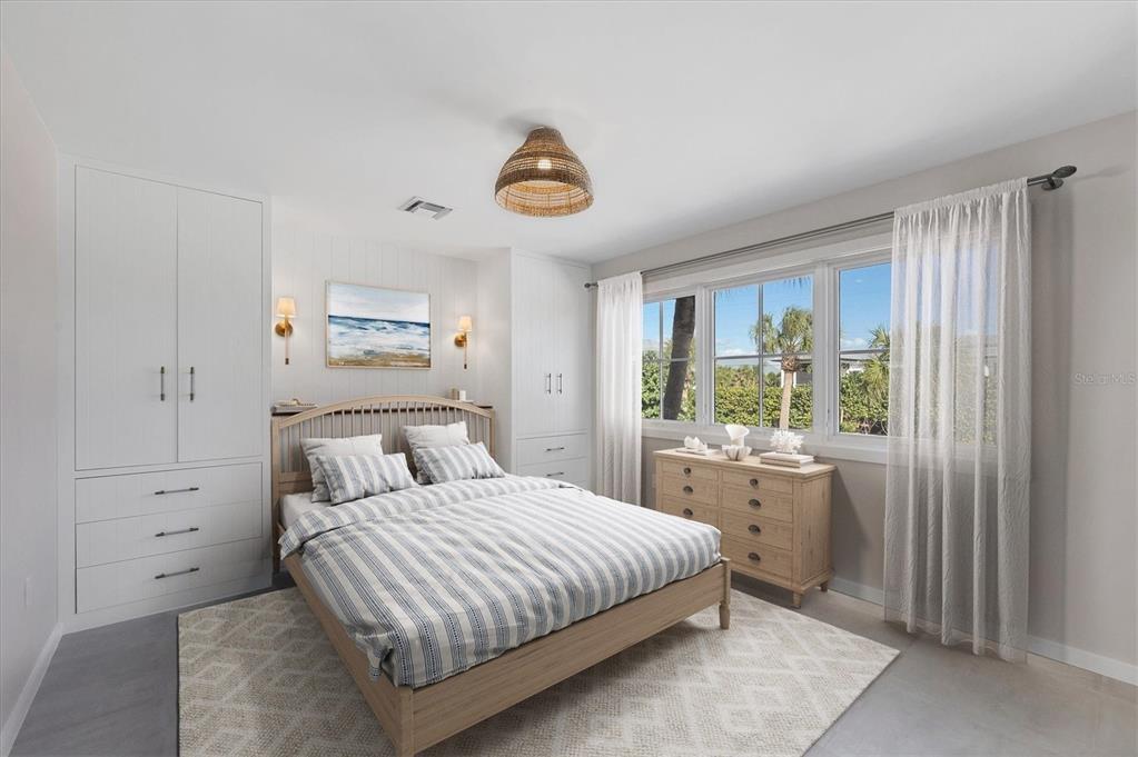 290 Gulf Boulevard, Unit 18 Boca Grande, FL 33921 - Photo 30 of 49 a bedroom with a bed and a window