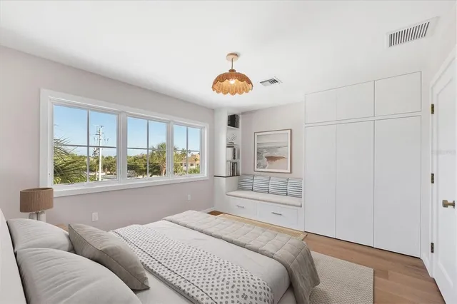 a bedroom with a bed and a large window