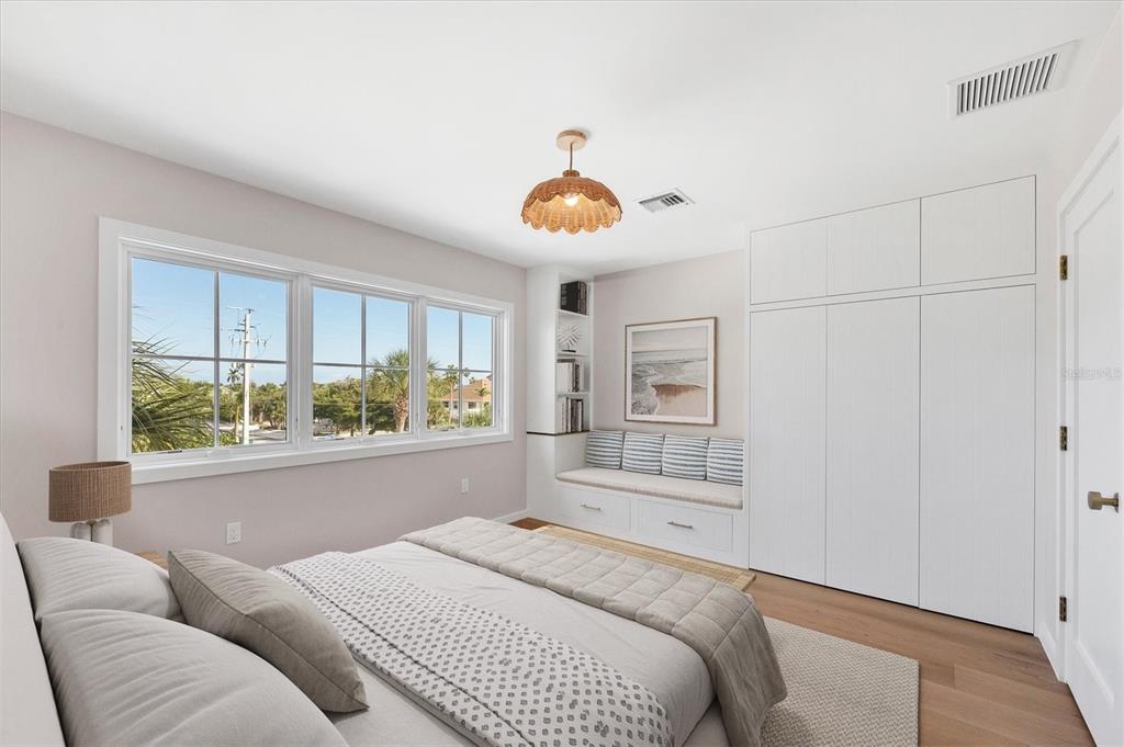 290 Gulf Boulevard, Unit 18 Boca Grande, FL 33921 - Photo 33 of 49 a bedroom with a bed and a large window