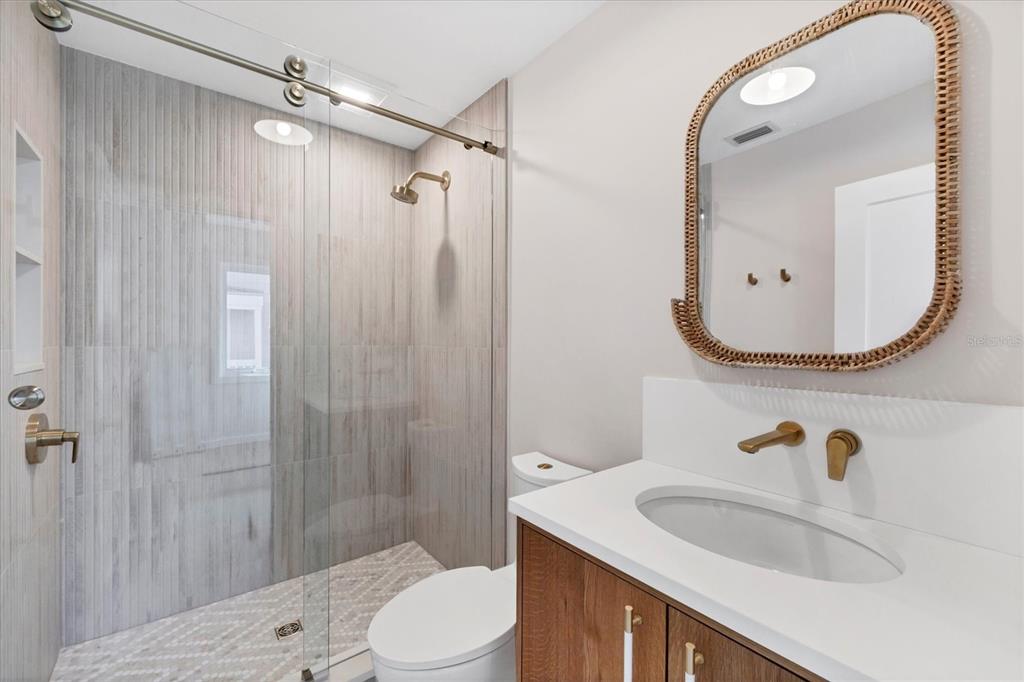 290 Gulf Boulevard, Unit 18 Boca Grande, FL 33921 - Photo 35 of 49 a bathroom with a sink a toilet and shower