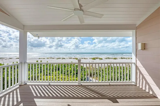 a view of a porch with wooden floor and fence