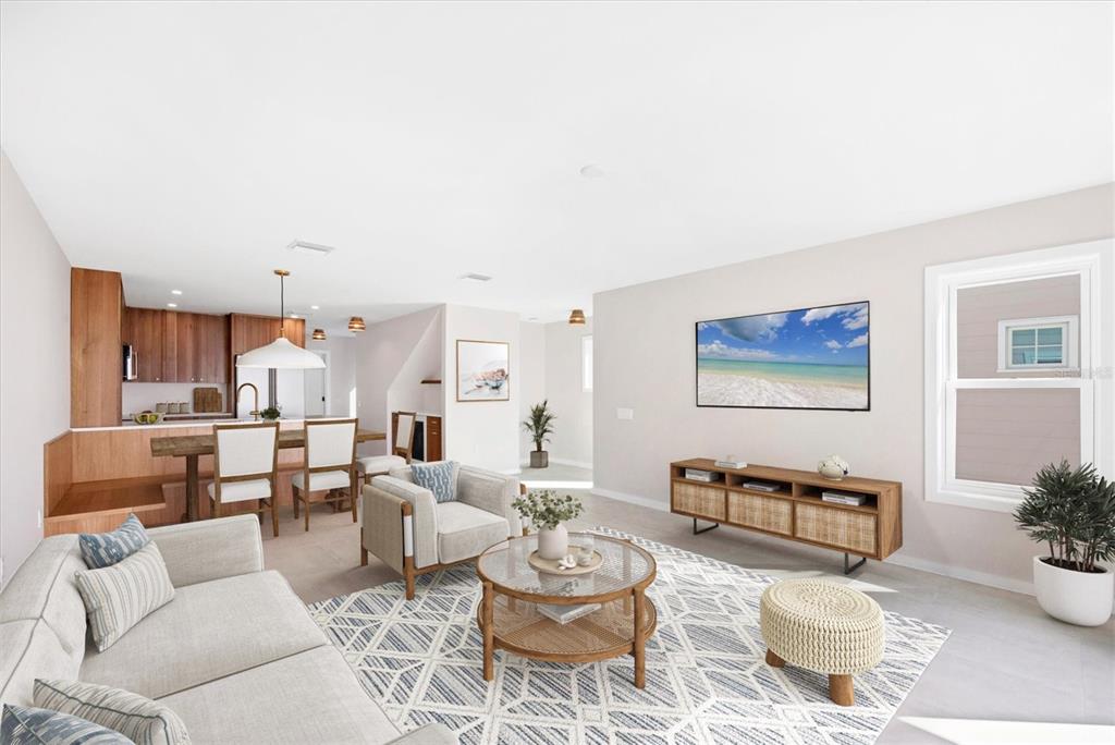 290 Gulf Boulevard, Unit 18 Boca Grande, FL 33921 - Photo 10 of 49 a living room with furniture and a dining table with kitchen view