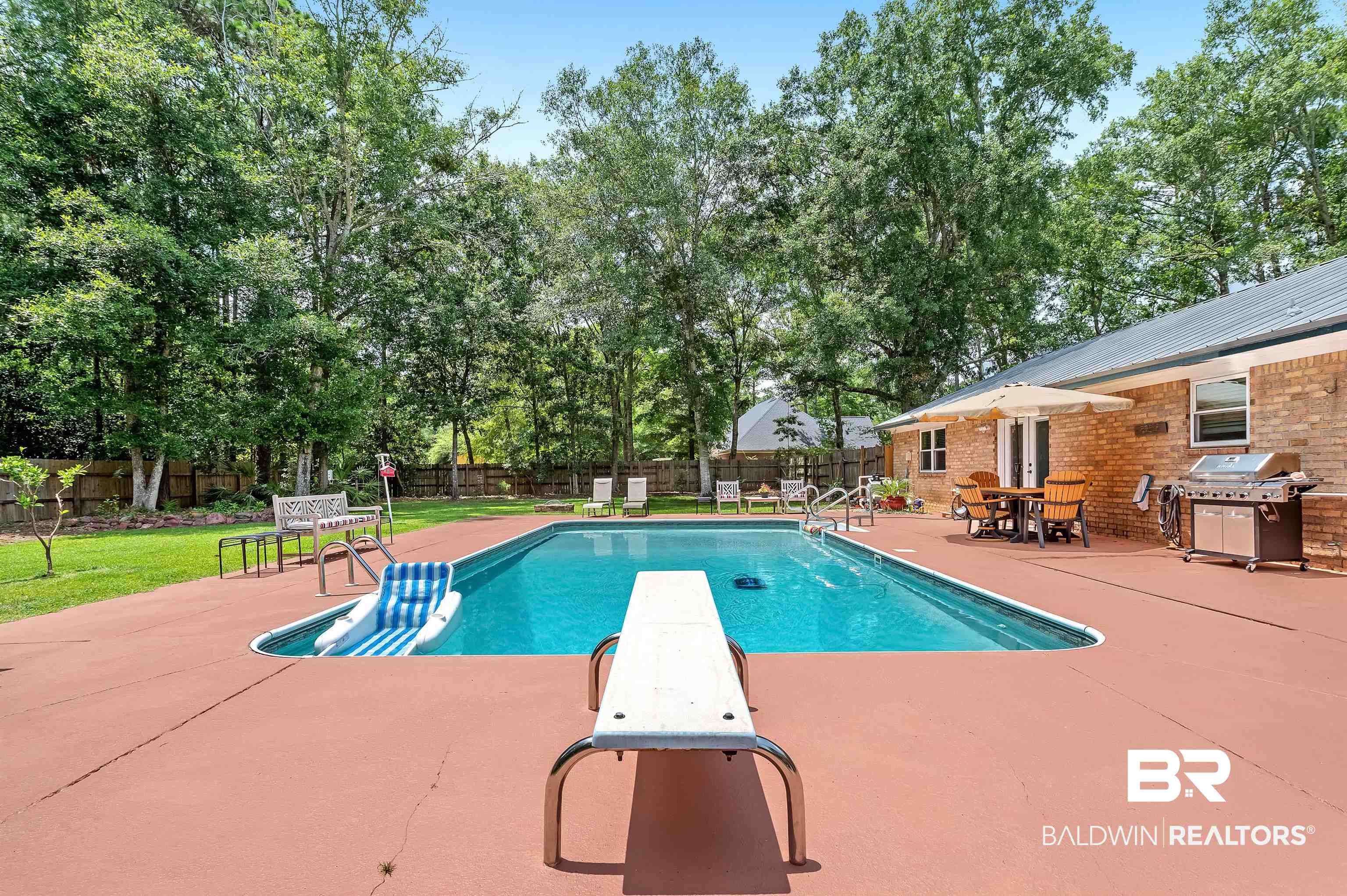 24551 Wolf Bay Drive Foley, AL 36535 - Photo 12 of 59 View of pool with a grill, a patio, a fenced backyard, and a diving board