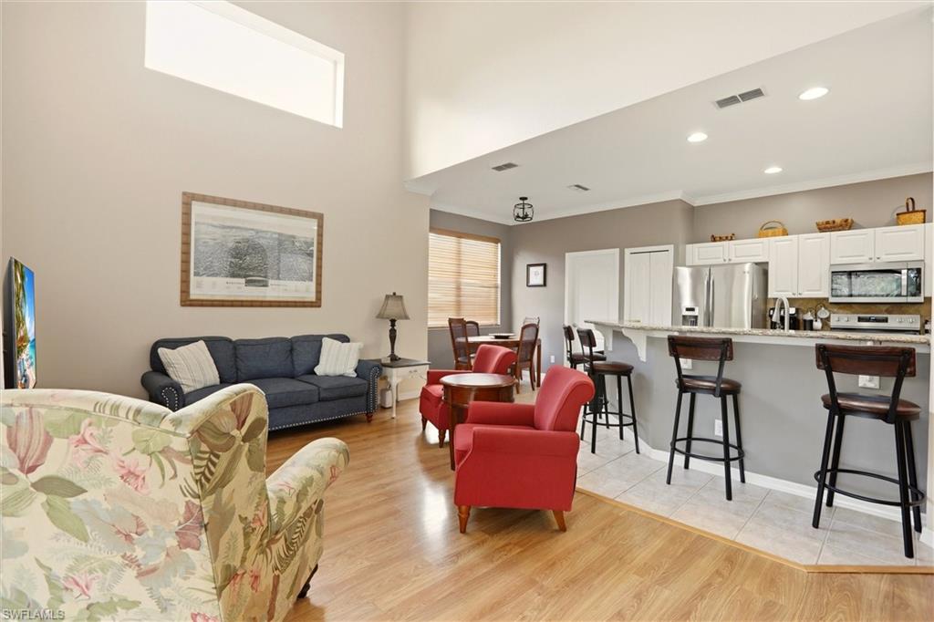 21524 Windham Run Estero, FL 33928 - Photo 12 of 50 a living room with lots of furniture and kitchen view