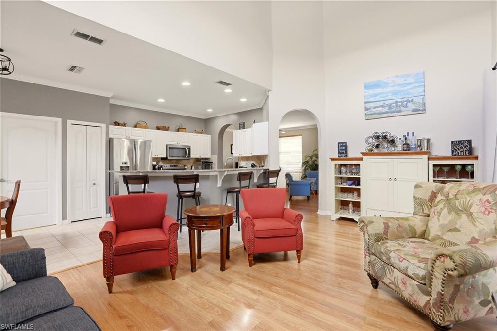 21524 Windham Run Estero, FL 33928 - Photo 15 of 50 a living room with furniture kitchen view and a wooden floor