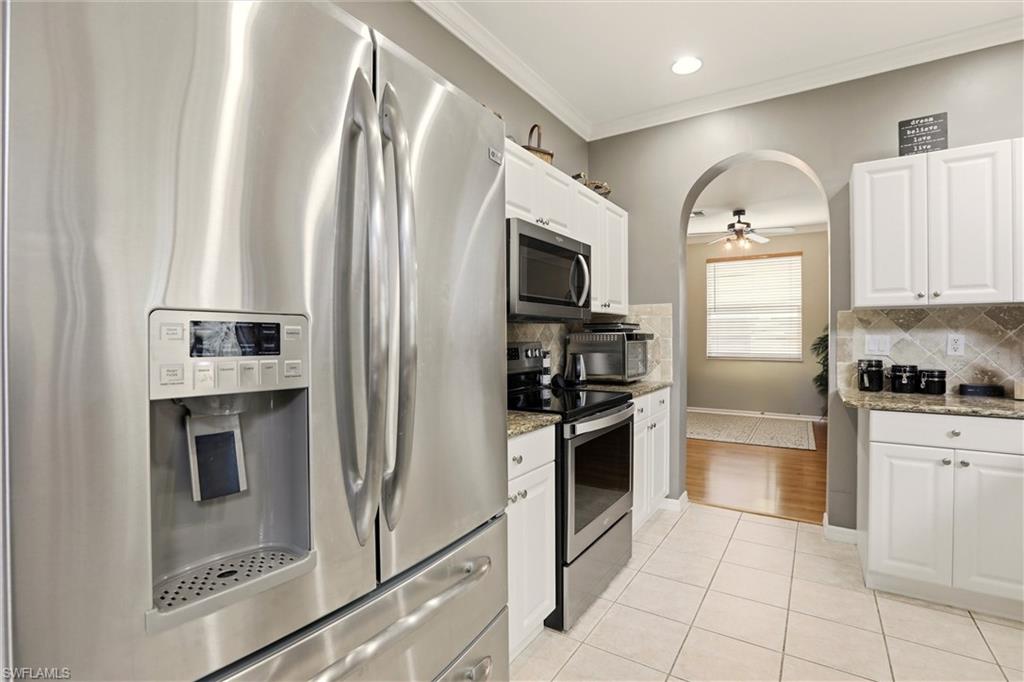 21524 Windham Run Estero, FL 33928 - Photo 17 of 50 a kitchen with stainless steel appliances granite countertop a refrigerator sink and stove