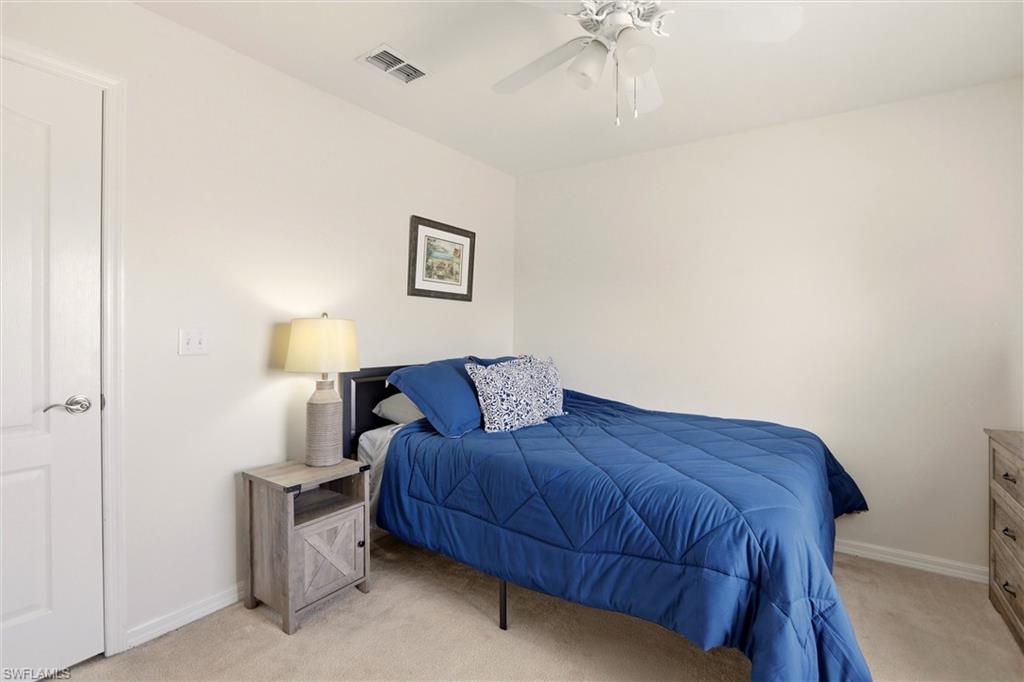 21524 Windham Run Estero, FL 33928 - Photo 29 of 50 a bedroom with a bed and a night stand