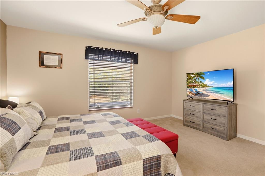 21524 Windham Run Estero, FL 33928 - Photo 30 of 50 a bedroom with a bed and a flat screen tv