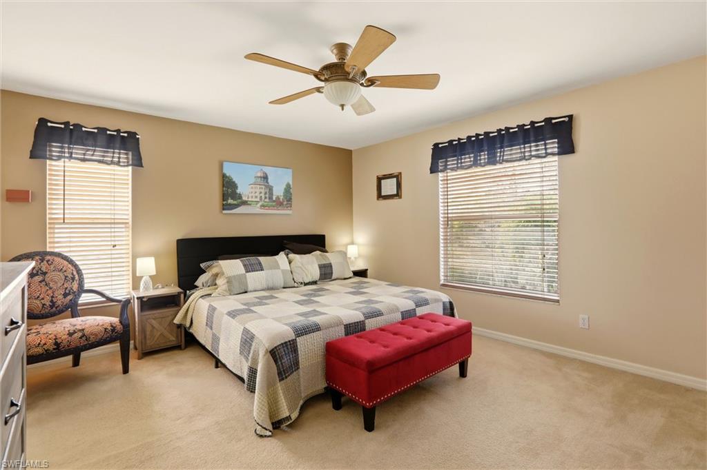 21524 Windham Run Estero, FL 33928 - Photo 31 of 50 a bedroom with a bed and a chandelier