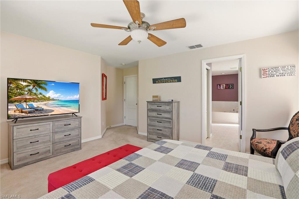 21524 Windham Run Estero, FL 33928 - Photo 34 of 50 a bedroom with a bed and a flat screen tv
