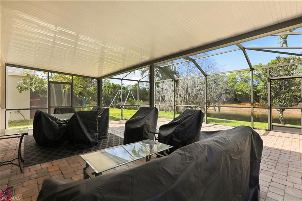 21524 Windham Run Estero, FL 33928 - Photo 39 of 50 a living room with furniture tv and large windows