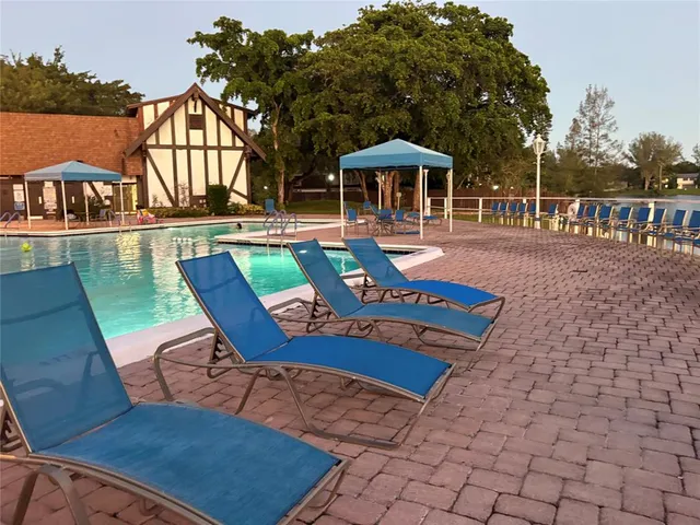 swimming pool view with a seating space