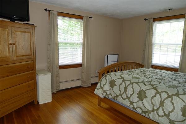 43 Boston Road Groton, MA 01450 - Photo 14 of 23 a bedroom with a bed and wooden floor