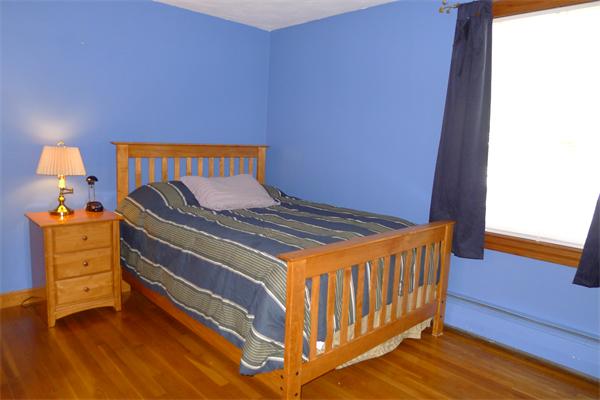 43 Boston Road Groton, MA 01450 - Photo 16 of 23 a bedroom with a bed and wooden floor
