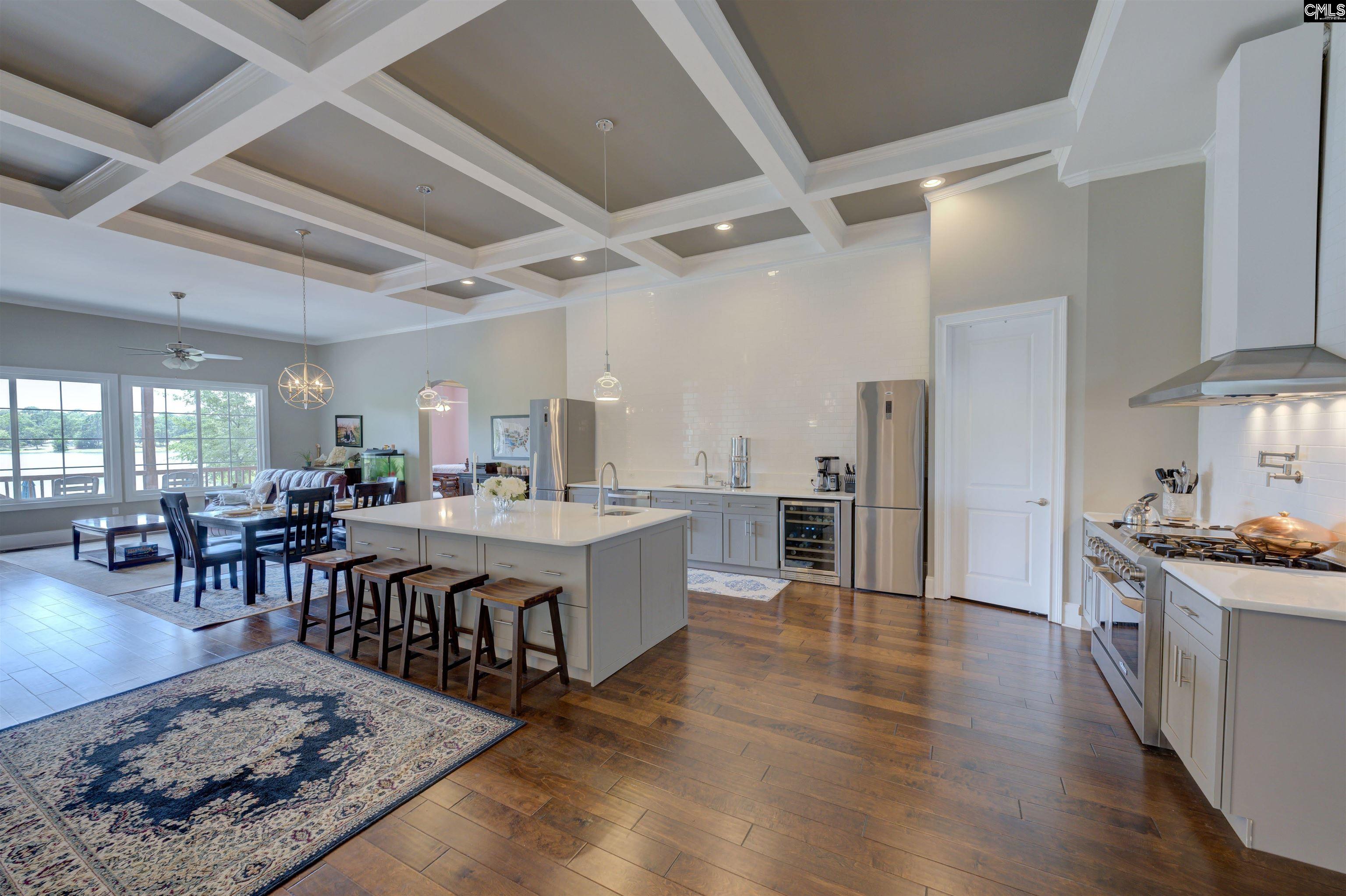 305 Northlake Road Columbia, SC 29223 - Photo 5 of 46 a large hall with stainless steel appliances granite countertop a stove oven a dining table and chairs with wooden floor