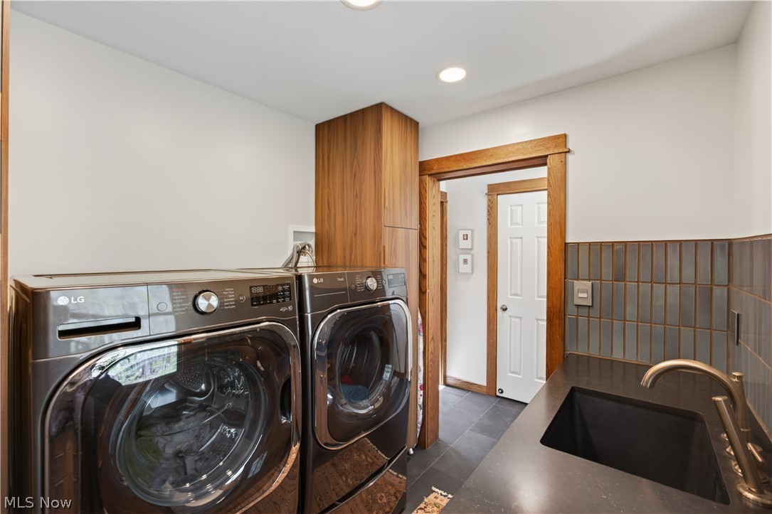 31599 Fairview Road Chagrin Falls, OH 44022 - Photo 20 of 50 The first floor Laundry Room is half tiled and fitted with cabinetry and a black granite folding counter