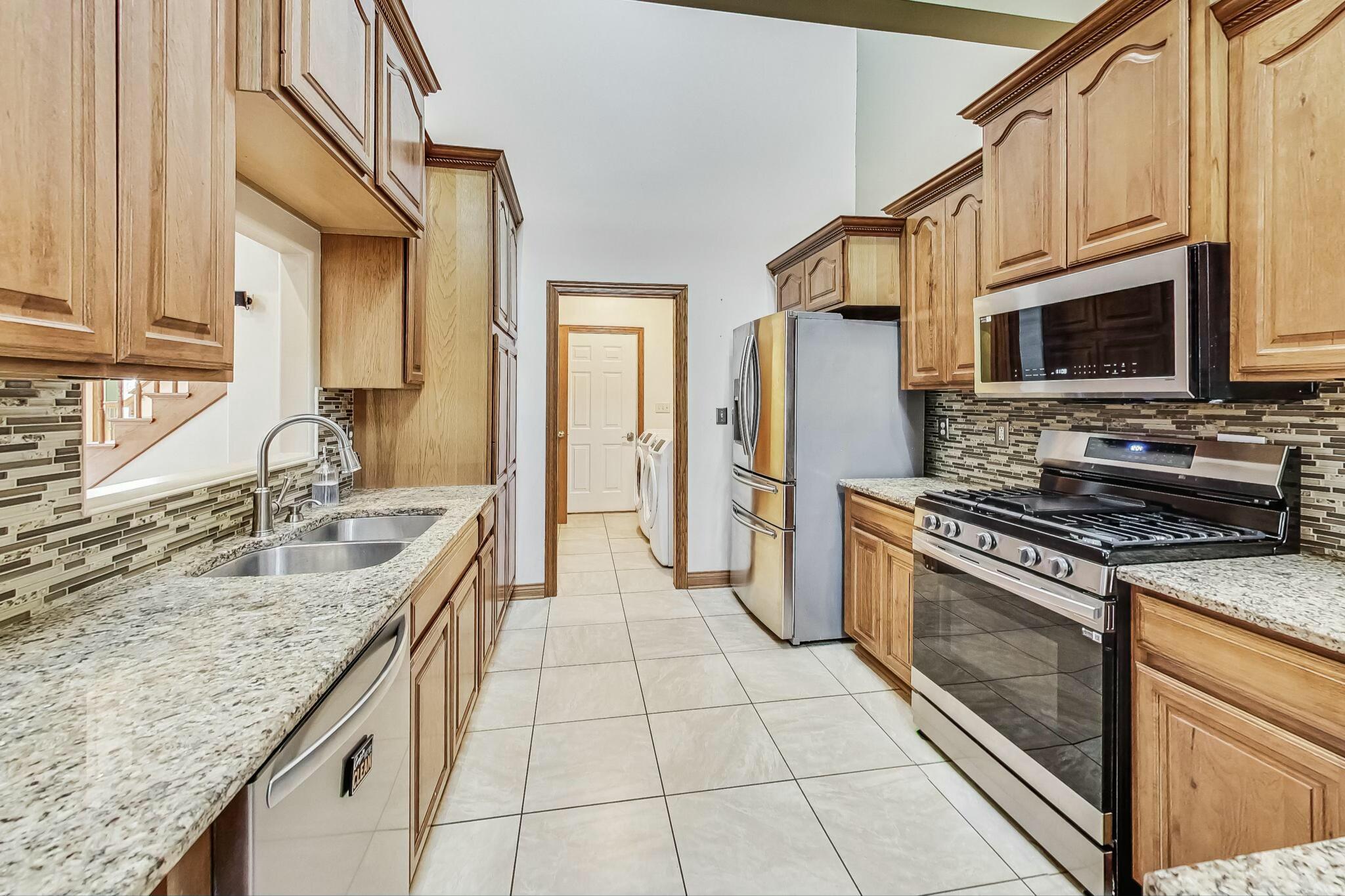 3519 Wicker Avenue Highland, IN 46322 - Photo 12 of 49 a kitchen with stainless steel appliances granite countertop a sink stove and refrigerator
