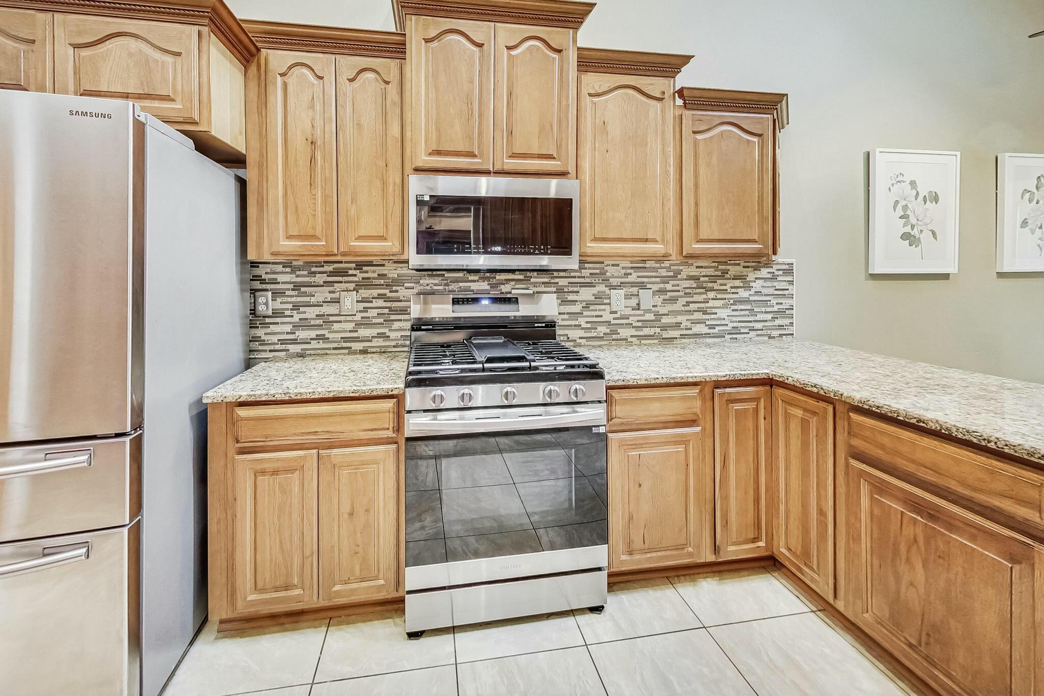 3519 Wicker Avenue Highland, IN 46322 - Photo 13 of 49 a kitchen with granite countertop white cabinets stainless steel appliances and sink