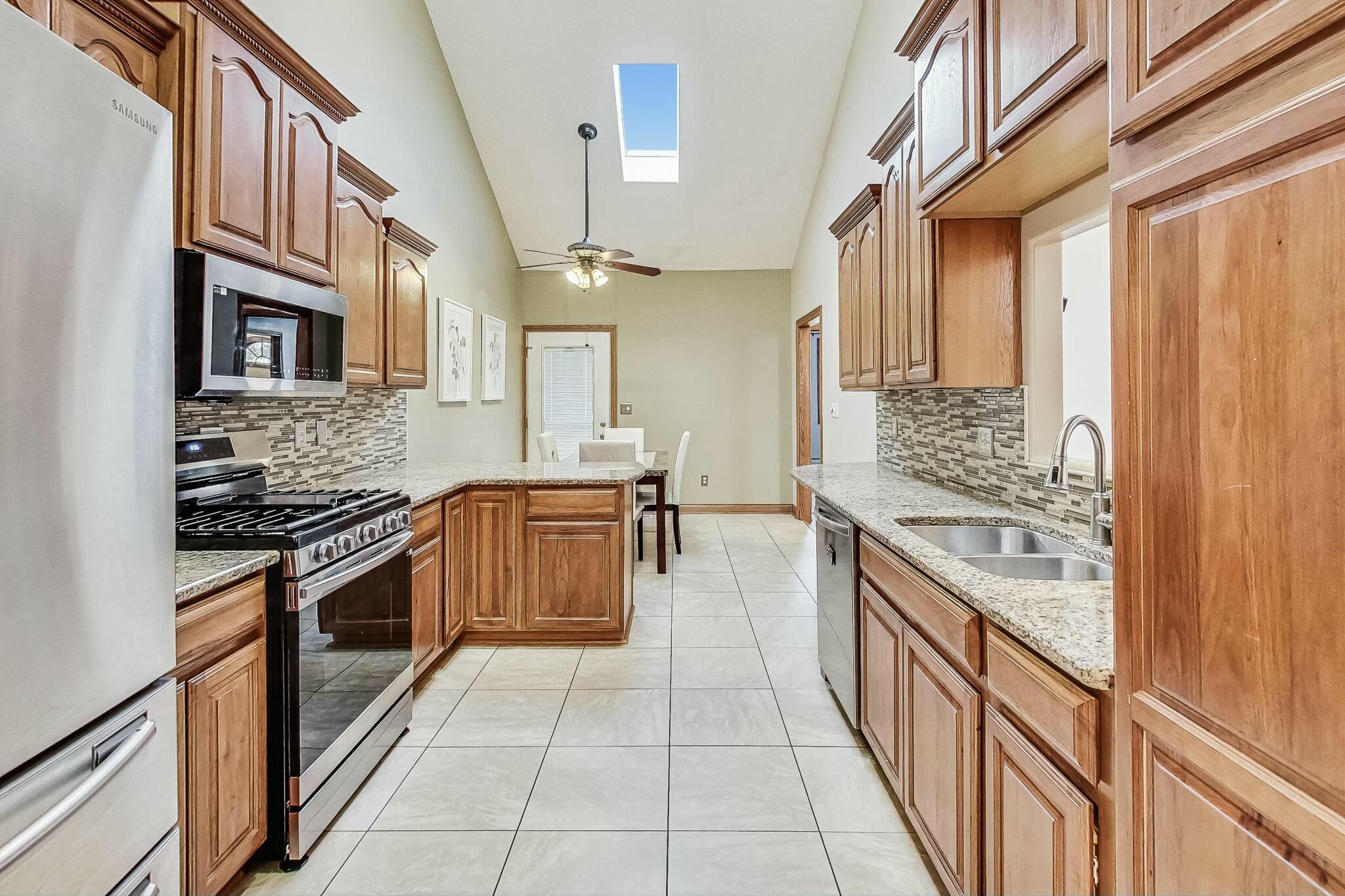 3519 Wicker Avenue Highland, IN 46322 - Photo 14 of 49 a kitchen with stainless steel appliances granite countertop a stove and a sink