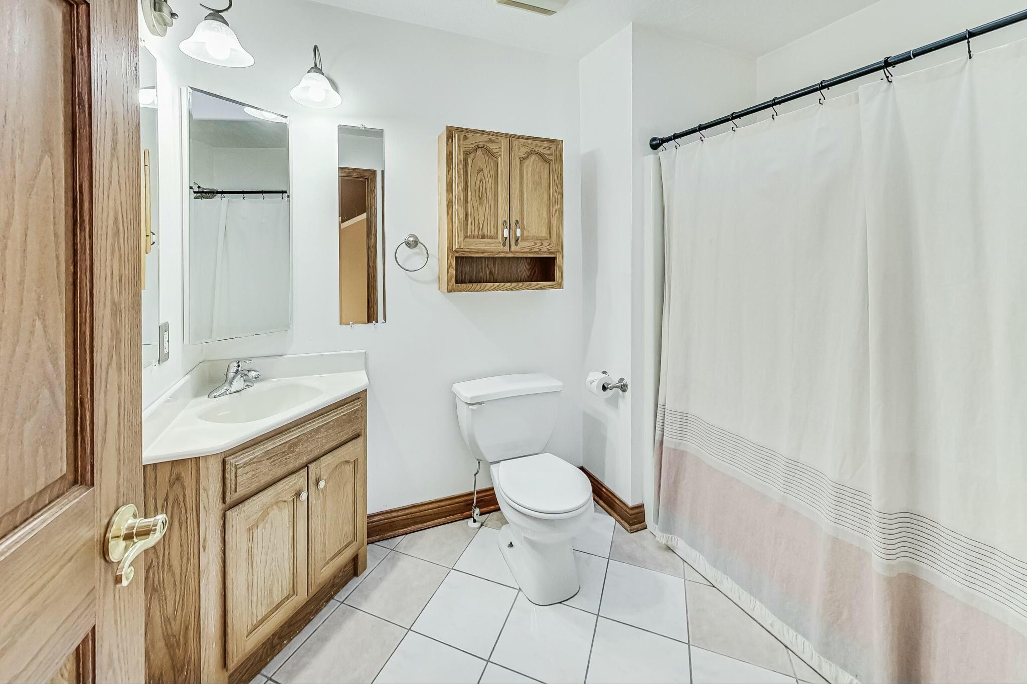 3519 Wicker Avenue Highland, IN 46322 - Photo 33 of 49 a bathroom with a toilet sink and mirror