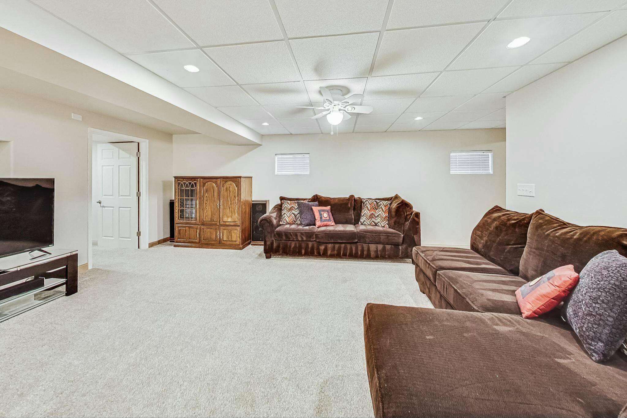3519 Wicker Avenue Highland, IN 46322 - Photo 35 of 49 a living room with furniture a flat screen tv and a ceiling fan