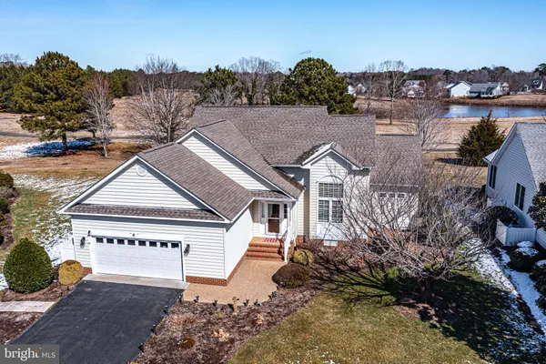 a view of a house with a yard and potted plants