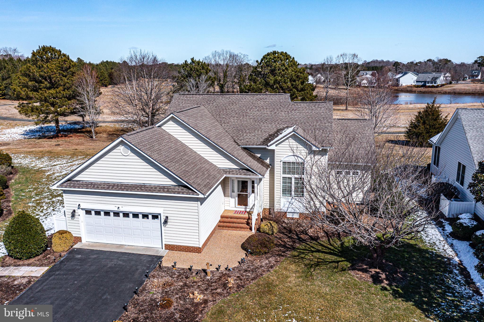 a view of a house with a yard and potted plants