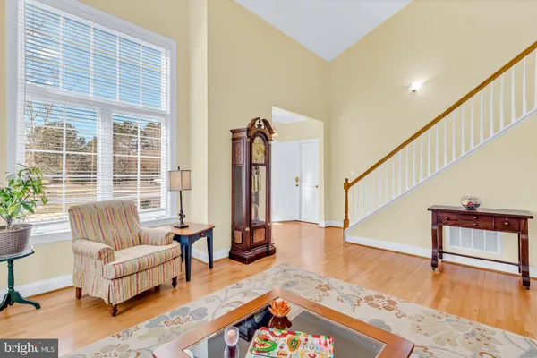 a view of a dining room with furniture a chandelier and wooden floor