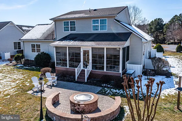 a view of a swimming pool with a patio and a yard