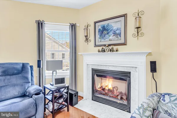 a kitchen with granite countertop wooden floors a refrigerator a stove a sink and cabinets